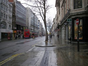 Rainy London street with red bus